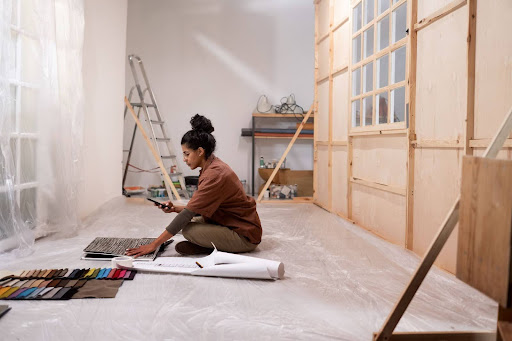 woman taking pictures of renovation plans
