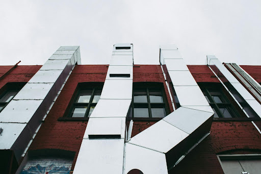 brown concrete building with grey air ventilation